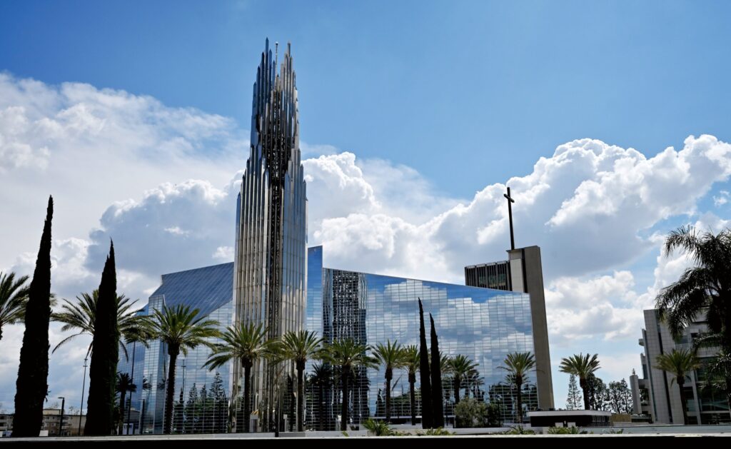 modern glass cathedral with palm trees reflected in the windows